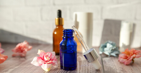 bottles and a pipette with hyaluronic serum for cosmetic and cosmetic procedures on a wooden...