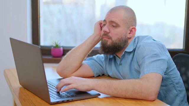 Killing boredom gesture, business man looking computer screen at home office. Annoyed man making suicide gesture at remote workplace indoor 4k