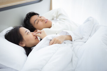 A woman closed her nose because of the bad breath of her lover, selective focus.