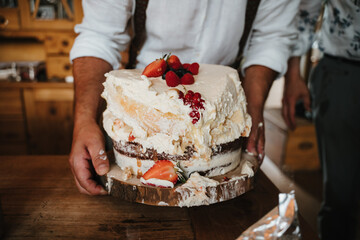 photo of a smashed homemade white strawberries cake