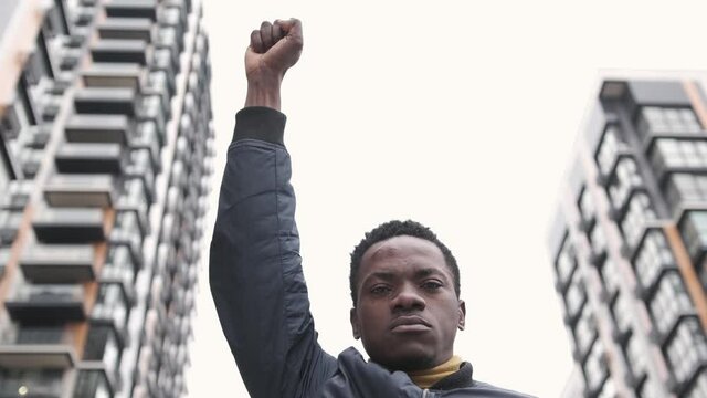Close-up of a young african american man rasises his first in solidarity for social and racial justice. Black lives matter. Social and racial justice concept 4k