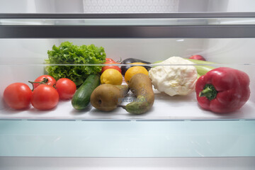 Frozen food in the refrigerator. Vegetables on the freezer shelves. Stocks of meal for the winter..