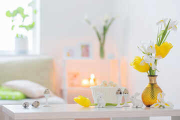 Easter decorations with spring flowers in white interior