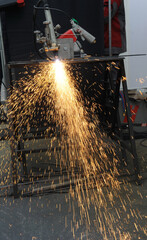 Welder. Detail of a welder performing an operation. Spark.