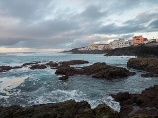 Natural sea swimming pool Los Charcones de Banaderos with waves of atlantic ocean during sunset, Gran Canaria, Canary Islands, Spain
