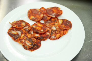 Spicy sausage sliced ​​and placed on a plate.