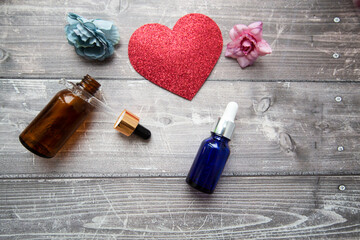 bottles and a pipette with hyaluronic serum for cosmetic and cosmetic procedures on a wooden...