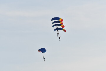 Parachute jumper. Romanian parachutist holding the Romanian flag in his hand.