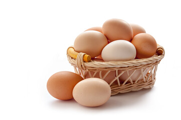 Organic eggs in the basket on the white background