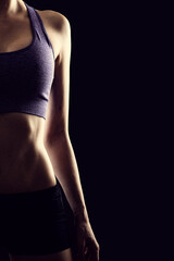 Obraz premium Slim beauty athletic woman on black background