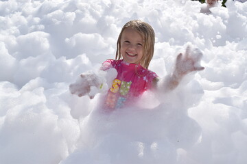 happy beautiful cute smiling  little blonde girl  Beach disco. Foam disco. Water Park 