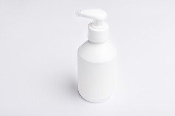 Mock up photo of white bottle for cream over white background.