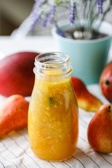 Fototapeta na wymiar citrus tea with mango and pear in a glass jar