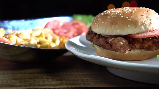 Panning of a spicy zinger burger.