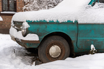 Kyiv (Kiev), Ukraine - January 15, 2020: An old rusty car is covered with snow