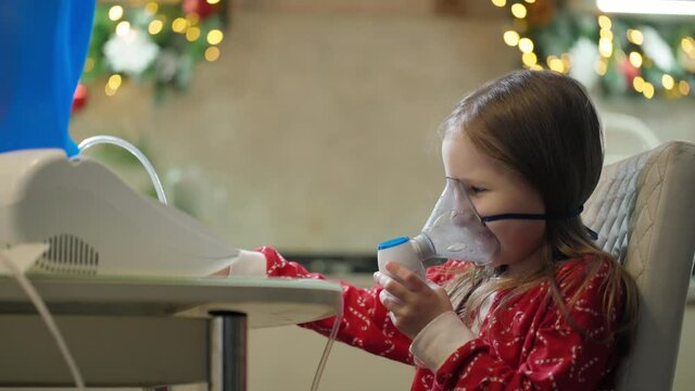 Teenage girl breathes in an oxygen mask. Inhalation of the respiratory tract. Mask inhaler. Child Girl In A Mask For Breathing Inhalation Medication
