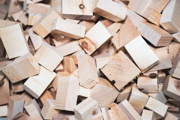 A pile of wooden blocks cut into cubes, all scattered on top of each other. background, texture concept