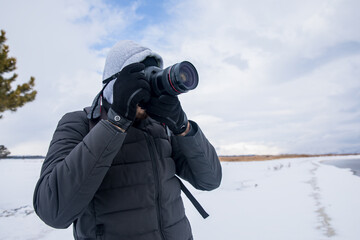 Obraz premium man holding camera in winter day