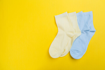 View from above. Socks are scattered on a yellow background. Clothing in the form of socks.