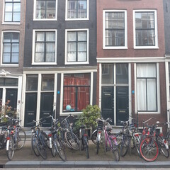 Fototapeta na wymiar Amsterdam, Netherland. Bicycles stand near residential buildings.
