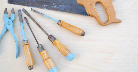 Old fashioned kids tools on wood background
