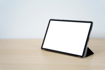Digital tablet with empty white display on wooden table - Powered by Adobe