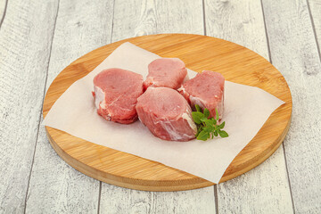 Raw pork medallion served rosemary