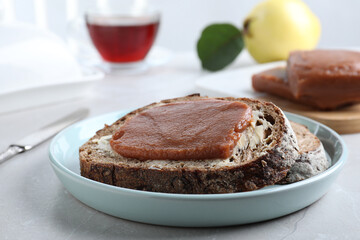 Tasty sandwich with quince paste served for breakfast on light table, closeup