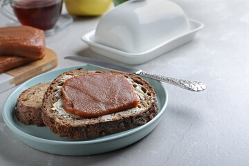 Tasty sandwich with quince paste served for breakfast on light table
