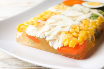 Delicious fish aspic with vegetables on plate, closeup