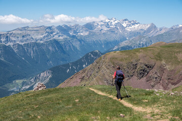 Fototapeta na wymiar trekker at route of ascent to Punta Suelza whit Pineta Peaks, 2972 meters, Huesca, Spain