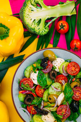 healthy food. Greek Salad with cheese, cucumbers, tomatoes and olives on a decorated table