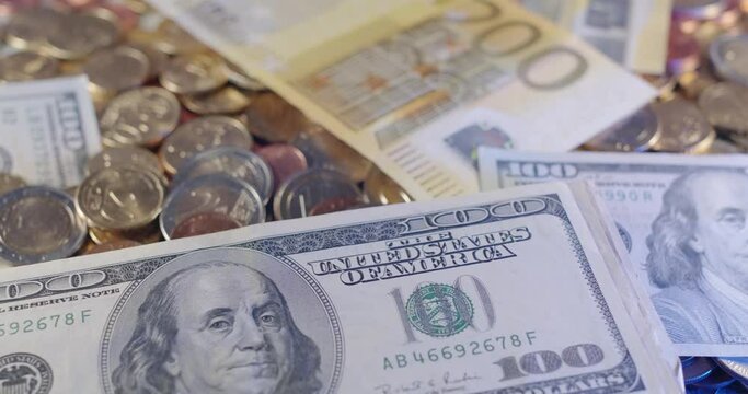 One Hundred Dollar Bill and Euro Coins and Banknotes. Two Hundred Euros in the Back with Old and New Design