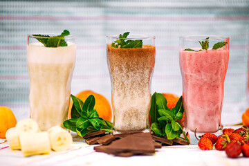 milkshake with berries and fruits on a decorated table