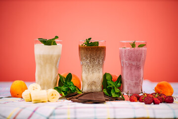 milkshake with berries and fruits on a decorated table