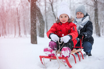 Children enjoying sleigh ride outdoors on winter day