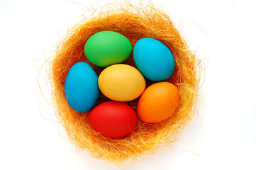 Colored Easter Eggs in the nest on the white background