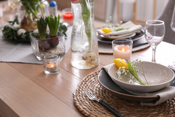 Beautiful Easter table setting with beautiful flowers indoors