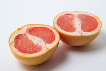 Naklejka na ściany i meble Grapefruit on a white background. A grapefruit cut in half. Citrus fruit. Exotic fruit