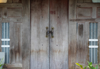 The old wooden house door has a lock in the Asian area. Simple design