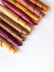 Fruit leather roll, pastille isolated on white background. Healthy snack food, natural nutrition for kids.
