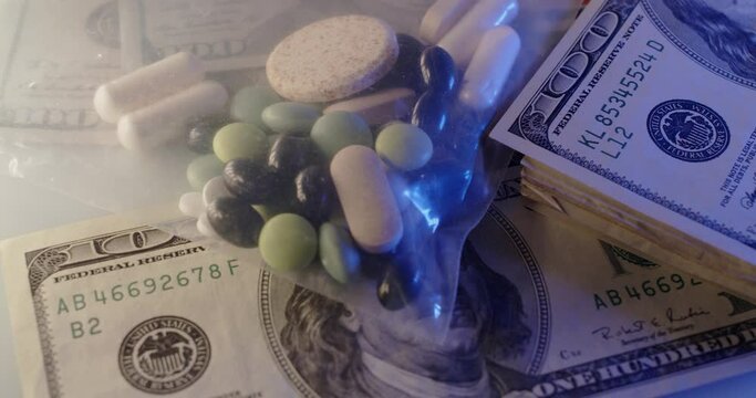Drugs in plastic bag on top of 100 Dollar Bills. Buying Drugs and medicine. Illegal Drugs and Steroids