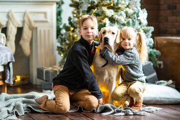 brother and sister with dog labrador