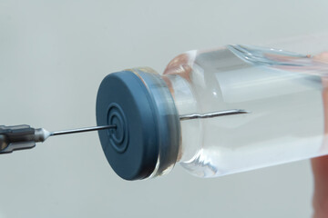 Fototapeta premium Process of taking medication using a syringe with a needle from a medical bottle, macrophotography. Concept of medicine, vaccination