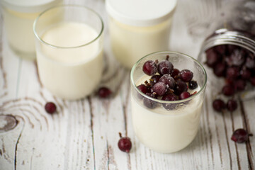 Homemade sweet yogurt with frozen berries in a glass