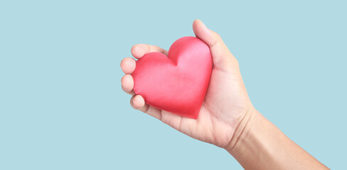 Hands holding red heart. heart health donation concepts