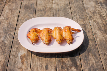 Grilled chicken wings on a wooden table