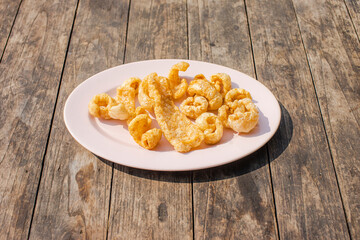 Fried dried pork on a wooden table