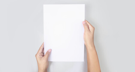 Hands holding paper blank for letter paper