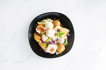 Spicy Meatball Salad meatballs on a black plate